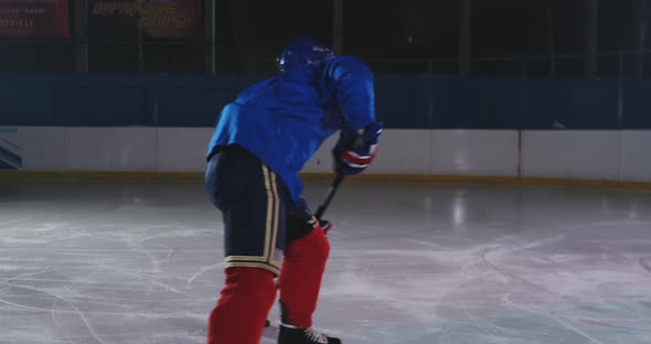 Hockey Player Conducts an Attack on the Opponent's Goal. Lying in a Helmet Catches the Puck alt