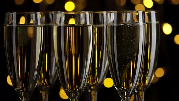 champagne. champagne glasses over Holiday Bokeh Blinking background alt