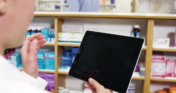 Pharmacist using digital tablet alt