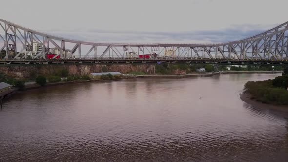 Aerial shot flying under Story Bridge on Brisbane River, Queensland alt