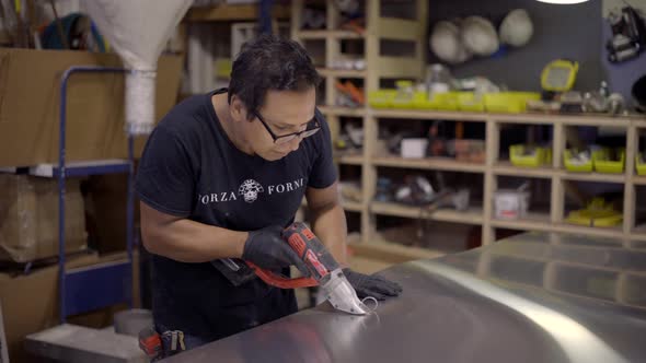 Worker cutting sheet metal in a shop alt