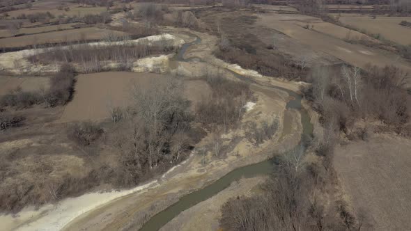 River coast polluted from mine drainage 4K aerial footage alt