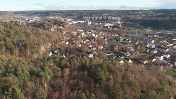 Nordic City Tucked Away in Vast Pine Forest Aerial Reveal alt