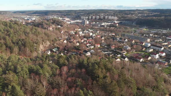 Nordic City Tucked Away in Vast Pine Forest Aerial Reveal