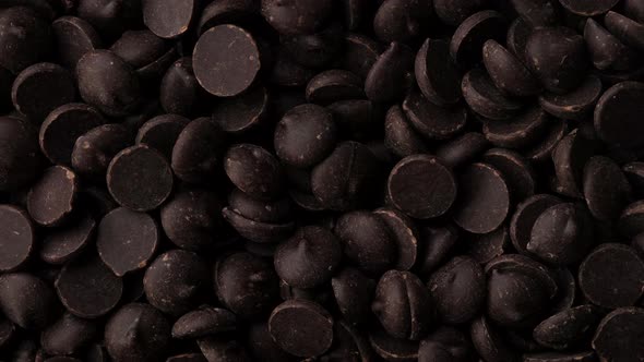dark chocolate chips top view rotating. confectionery concept alt