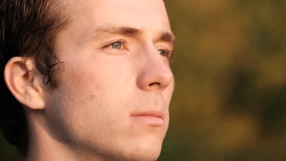 Extreme Closeup of the Eyes of a Young Attractive Man Enjoying the Sunset