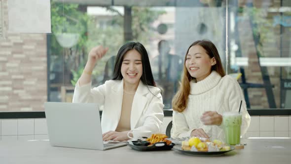 Two Asian women business partners, chatting in an internet cafe, food business concept combined