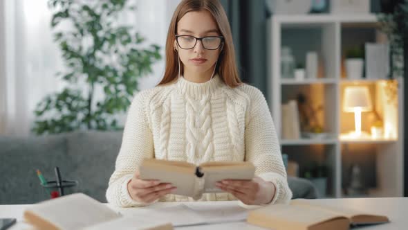 Focused Student Reading Book at Home alt