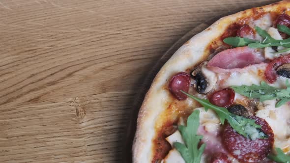 Appetizing Pizza on a Wooden Board in a Restaurant alt