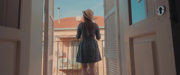 A young tourist woman at the balcony alt