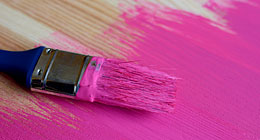 Pink paint and paintbrush