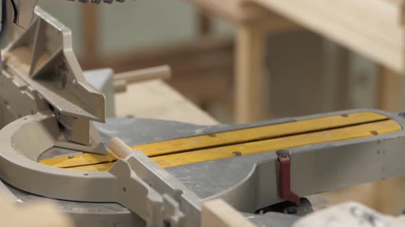 The Master Cuts a Wooden Peg with a Circular Saw in the Woodworking Workshop