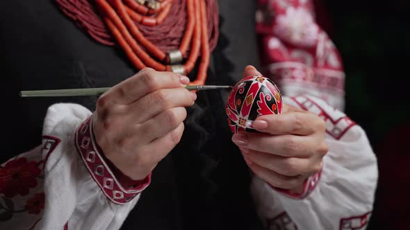 Ukrainian Woman Painting Traditional Ornamets on Easter Egg  Pysanka alt