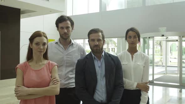 Team of professionals in lobby, portrait alt