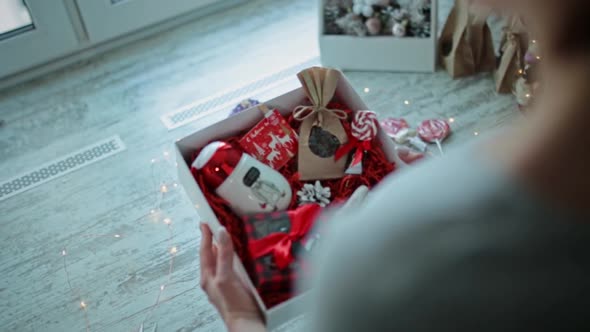 The Girl Collects a Christmas Present in a Box
