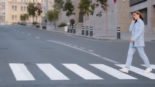 Young Girl Manager Business Woman Student in Stylish Blue Suit Walking Crosswalk in City Talking alt