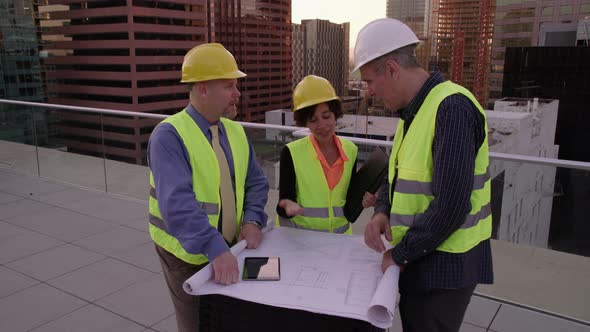 Three architects look over plans together