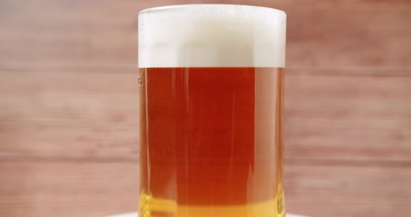 Craft Full Beer Into the Large Glass Beer Mug On a Wooden Background alt