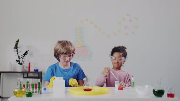 Science Research in Chemistry. Two Diverse Kids or Schoolchildren Makes Experiment alt
