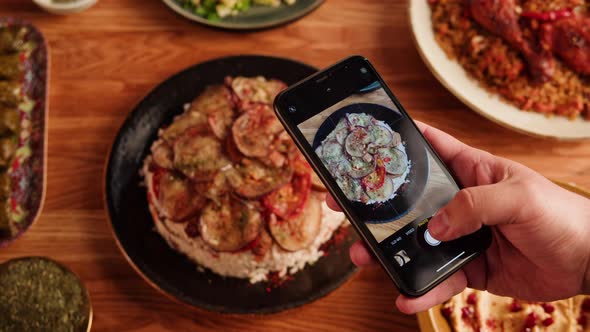 Maqluba Hummus Dolma Kabsa Tabbouleh Closeup Taking Photo on Smartphone Camera of Middle Eastern alt