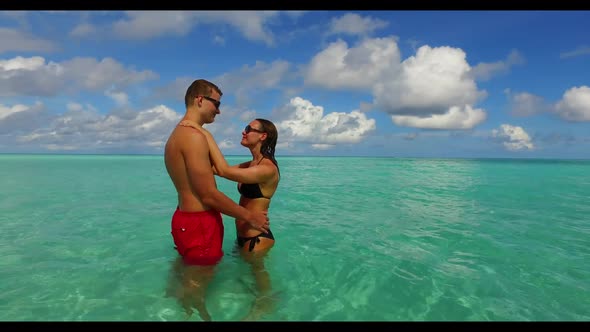 Family of two happy together on luxury coast beach time by turquoise lagoon and white sandy backgrou alt