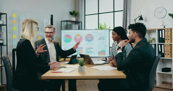 Mixed Race Businesspeople Putting Hand on Hand Making Tower as Symbol of Partnership alt