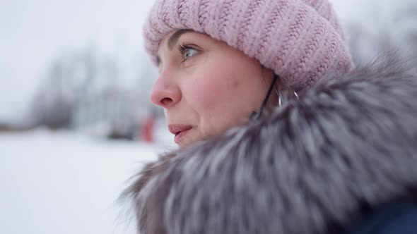 Side View Closeup of Excited Young Woman Admiring Winter Mountains Outdoors alt