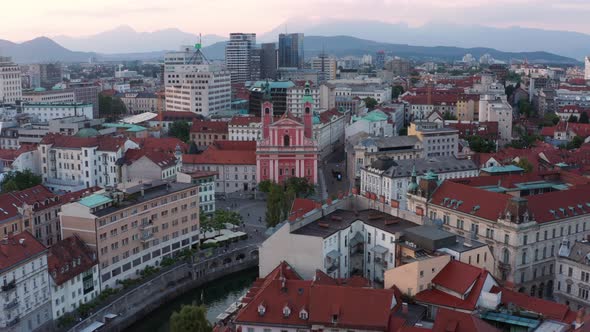 Flying Towards The Franciscan Church of the Annunciation With Red Facade At Sunset In Preseren Squar alt