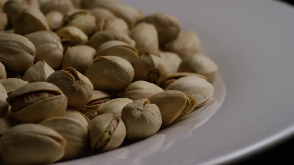 Cinematic, rotating shot of pistachios on a white surface - PISTACHIOS 040 alt