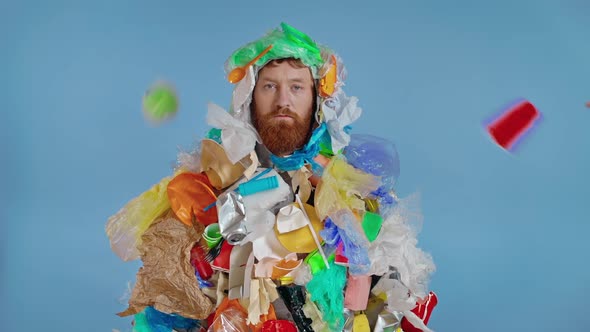 Plastic and other garbage falling on the man 