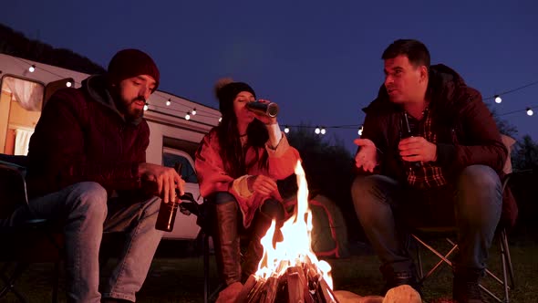 Caucasian Bearded Man Telling a Story to His Friends Around Camping Fire alt