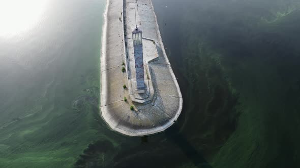 The Lighthouse with Sun Light and Algal Bloom alt