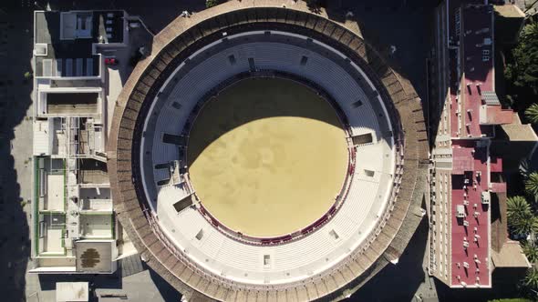 Historic round bullring for bullfighting in Malaga, Spain; aerial top-down