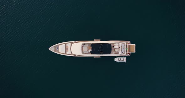 Luxury Yacht Boat Floating in Exotic Mediterranean Ocean Water - Aerial Overhead Top Down alt