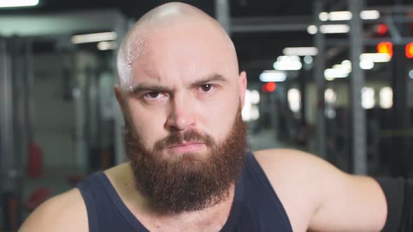 Active Handsome Athlete Standing Near Metal Bar After Training in Underground Garage alt