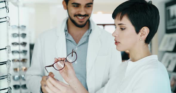 Beautiful Woman with Optician Trying Eyeglasses at Optics Store alt