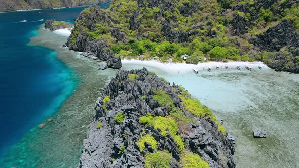 Aerial Drone Circle Movement Over Hidden Lagoon of Star Beach on Tapiutan Island Near Matinloc alt