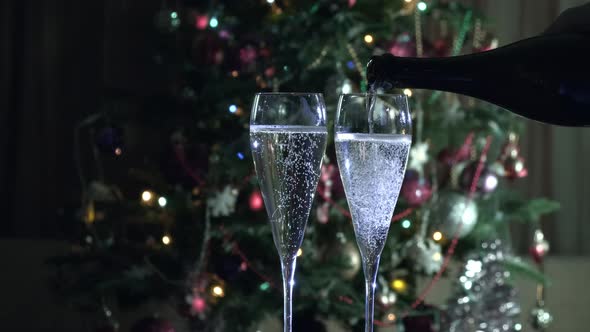 Two glasses with bubbly tasty sparkling drink. Pouring Champagne alt