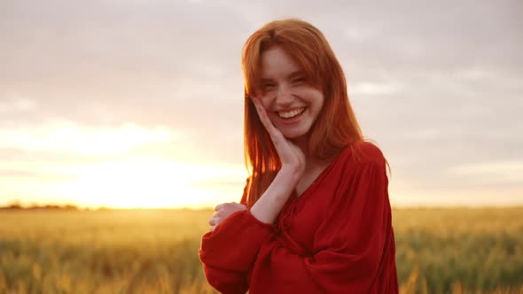 Romantic Girlfriend Redhead Girl Laughing and Having Fun Smiling at you Standing in Wheat Field at