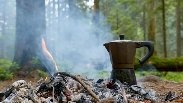 Coffee is Prepared in a Geyser Coffee Maker on a Campfire in the Forest alt