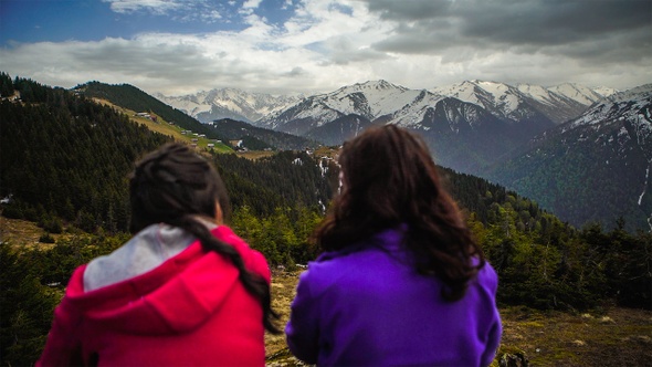 People watching mountain landscape