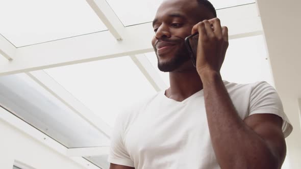 Young adult mixed race man enjoying time in his home alt