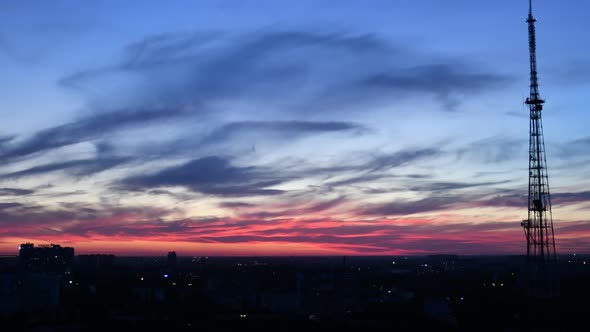 Time Lapse of Pink Blue Sky with Spindrift Purple Clouds and Silhouette of Communication Tower