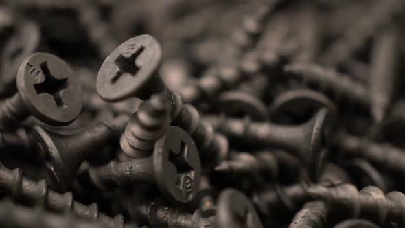 Many Self Tapping Screws Rotate Motion Background. Working Tools Close Up. alt