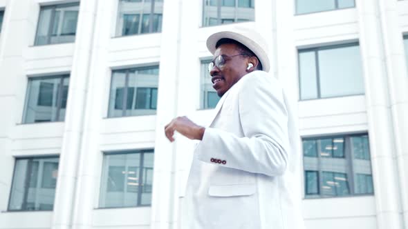 African American guy in yellow t shirt and white suit alt