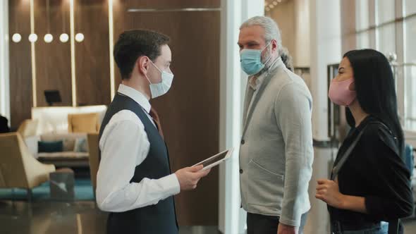 Hotel Manager Welcoming Guest Couple alt