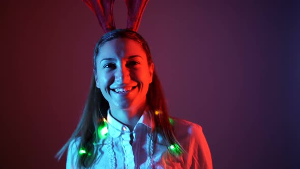 Portrait of Young Woman in Christmas Festive Outfit Laughing and Smiling Wide alt