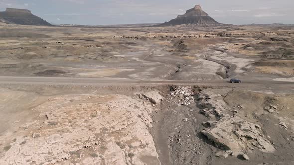 Aerial view of vehicle driving on muddy road after flood in the Utah desert alt