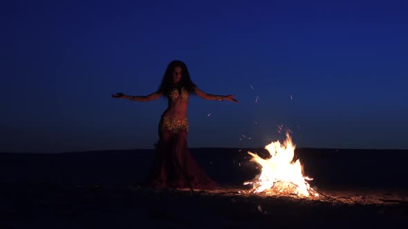 Dancer in Special Clothes Is Dancing Belly Dancing, Near the Fire alt