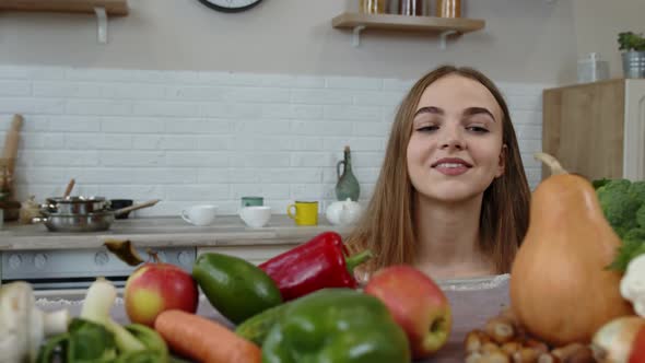 Lovely Young Girl Spying From Under the Table and Grabbing Fresh Apple and Eating It. Diet Concept alt